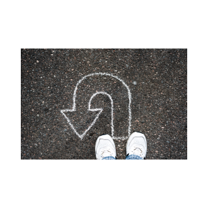 image of two feet and a white chalk arrow extending from the feet and turning to the left back towards the feet.